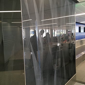 Custom glass wall-cladding on GeoLite Honeycomb Backer elevator at the United Airlines Terminal at Lax and etched on glass by Skyline Design, the industry-leading architectural glass manufacturer.